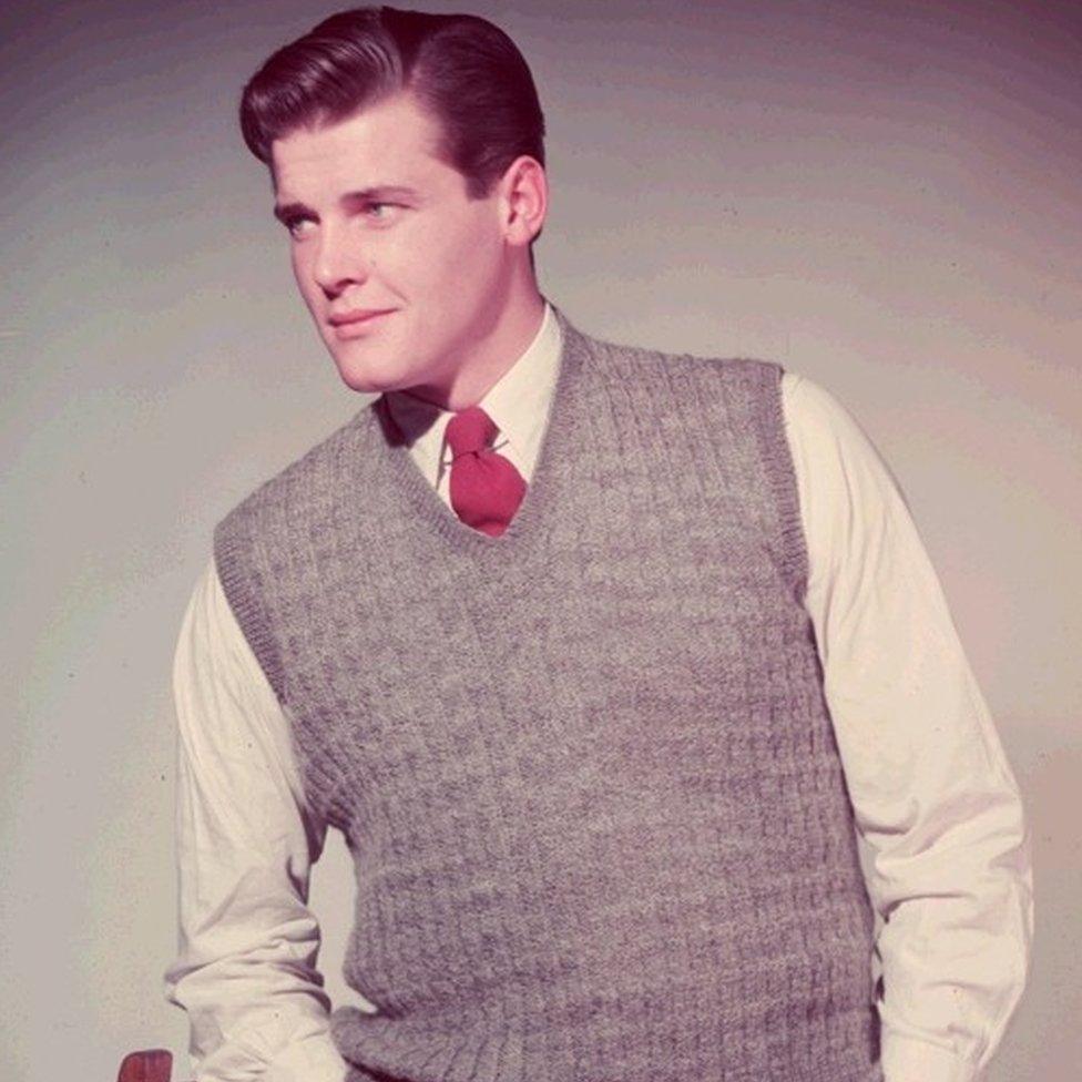 Roger Moore modelling a sweater in the 1950s