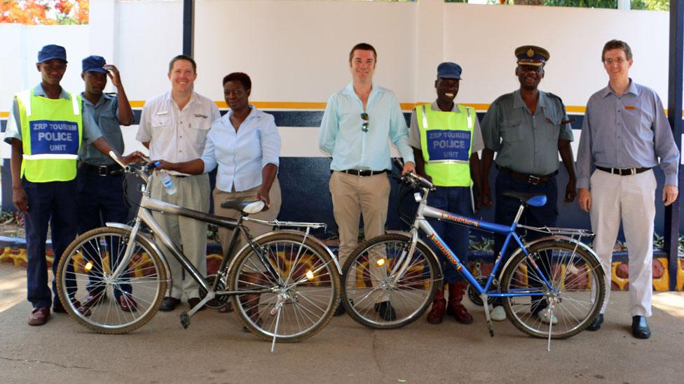 Victoria Falls tourist police are presented with bicycles by some of the local businesses who are helping to fund their work