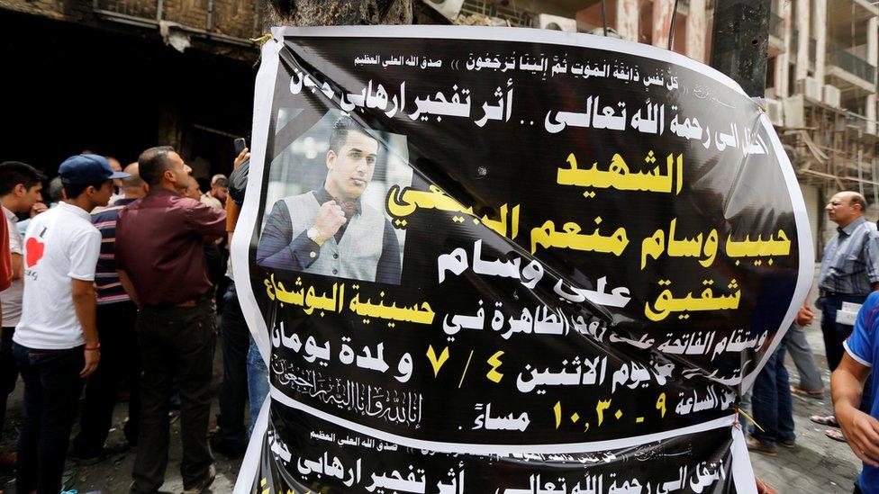 A funeral banner is seen at the site of the suicide bombing in Karrada, Baghdad (4 July 2016)