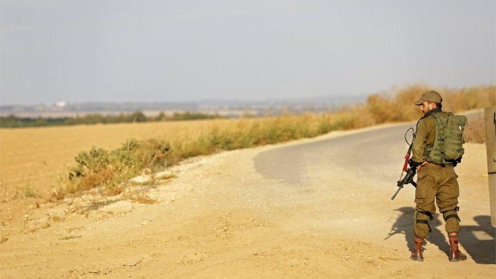 Israeli soldier watches the border with Gaza