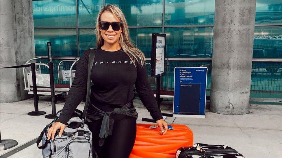 Carla Stefaniak posing with luggage