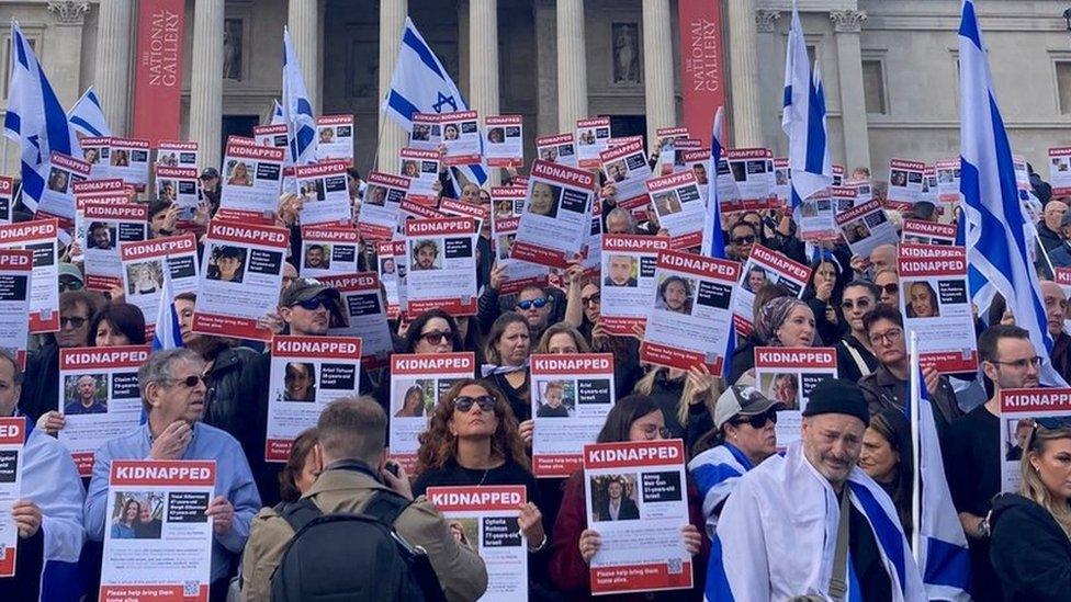 Members of the Jewish community show posters of missing Israelis