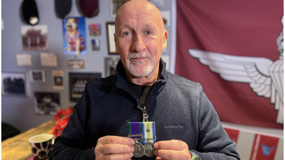 Mr Eamer holding his medals