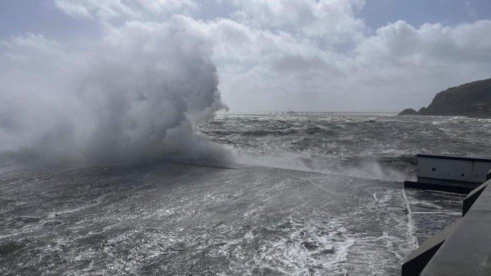 A large wave is seen off the coast in County Antrim, Northern Ireland