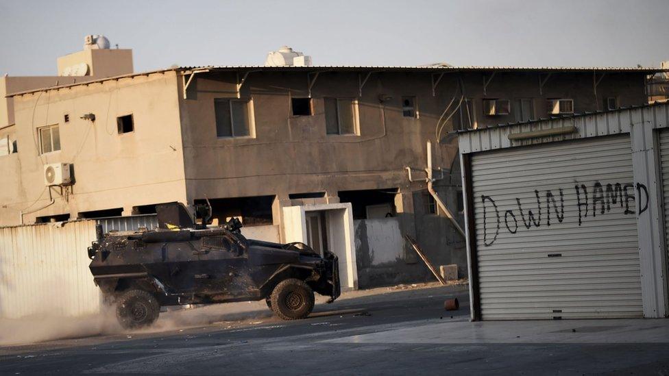 File photo showing Bahraini police vehicle patrols streets during clashes with protesters in Sitra, south of Manama, on 12 February 2016