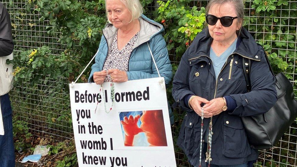 Some campaigners have placards with photos of foetuses