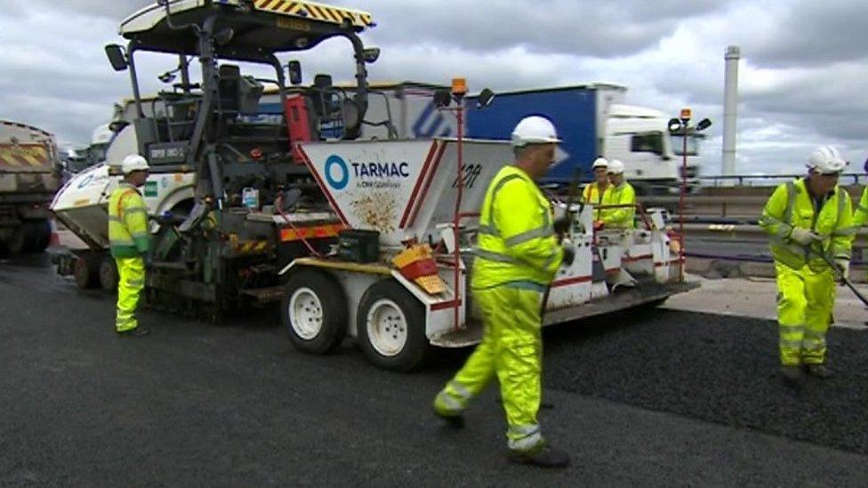 Workers repairing M5