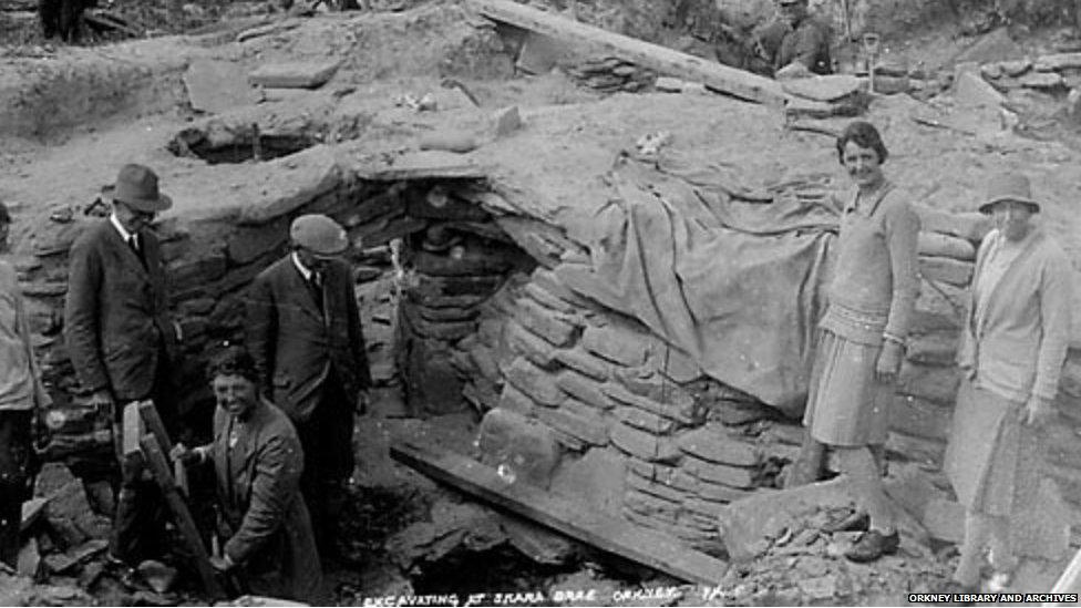 Women looking into archaeological trench