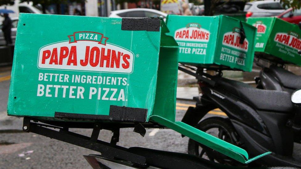 A photo of delivery bikes showing the Papa Johns logo