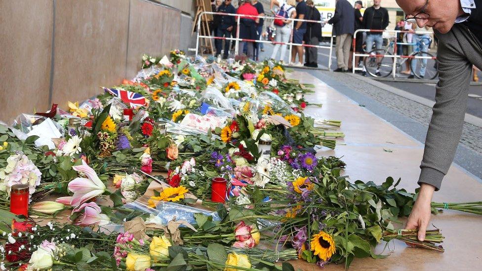 Flowers and flags outside the British Embassy in Berlin, Germany.