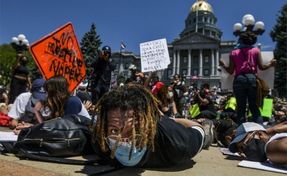 Thousands of people staged a die-in demonstration next to the Colorado State Capitol with their hands behind their backs to protest the death of George Floyd in Denver, Colorado, 30 May 2020