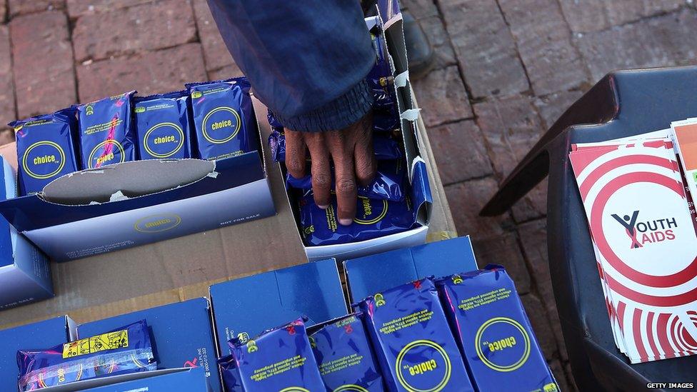 A Soweto youth takes packets of free condoms - 2010