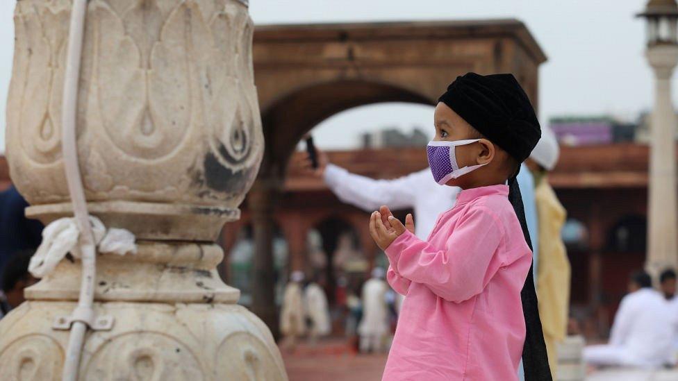 Muslim boy worshipping at the Jama Masjid in Delhi