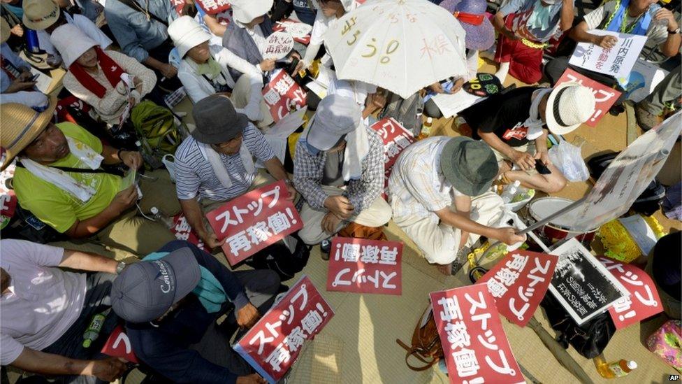 Protesters stage a rally near the gate of the Sendai Nuclear Power Station in Satsumasendai, Kagoshima prefecture, southern Japan, Tuesday, 11 Aug 2015.