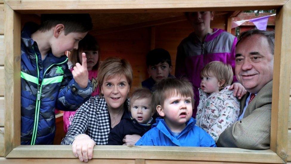 Nicola Sturgeon and Alex Salmond with a group of children