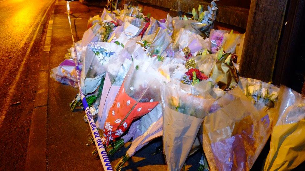 People have been leaving floral tributes at the property since police reopened the road on Thursday night.