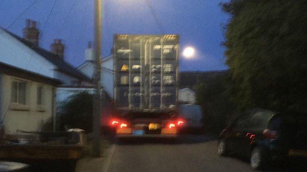 A lorry appears stuck on a narrow road in Gilwern