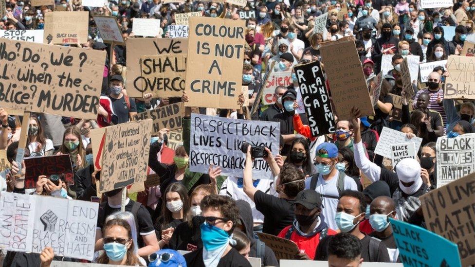 Protesters held placards during a demonstration at Glasgow Green in Glasgow on Sunday