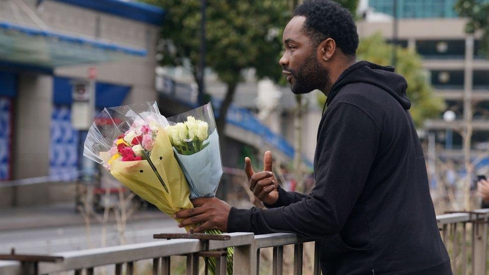 Man leaving flowers