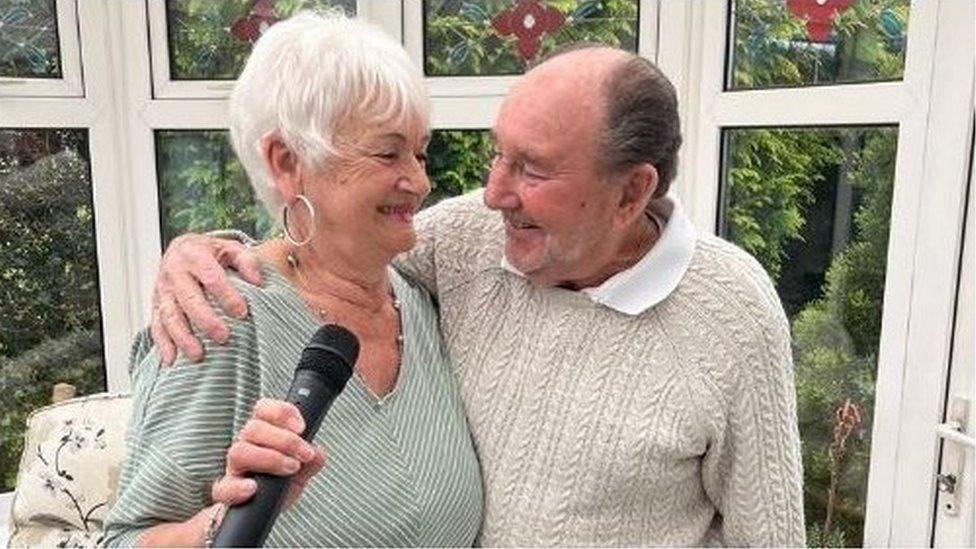 Barbara and Ken James looking at each other and singing