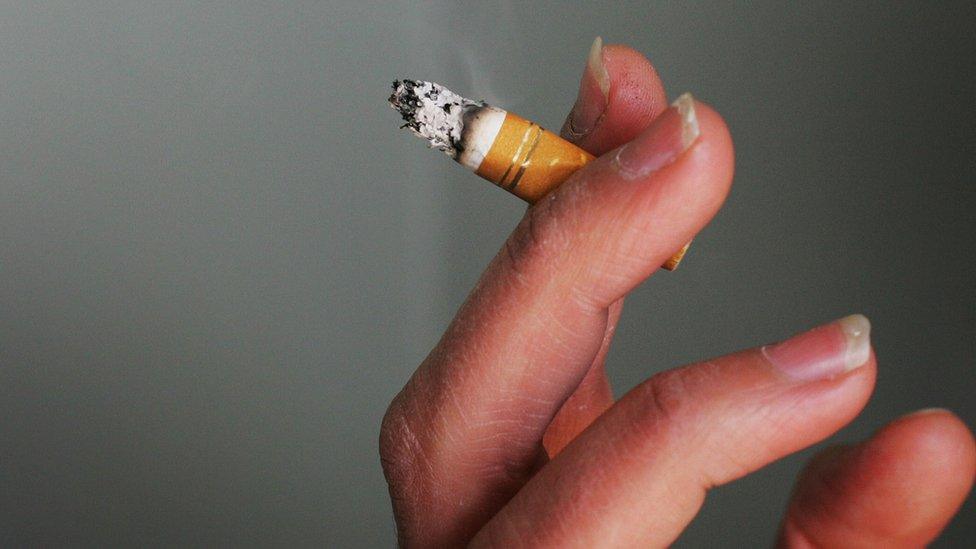 A young woman holds a cigarette in her hand outside a hotel in the Eastern Suburbs on July 30, 2008 in Sydney, Australia