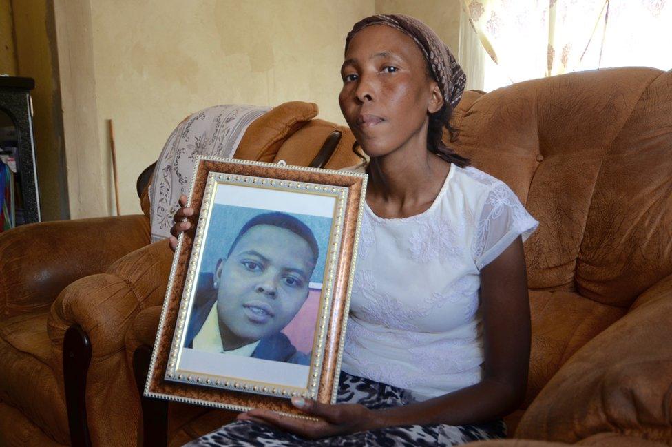 Betty Melamu holds up a picture of her daughter