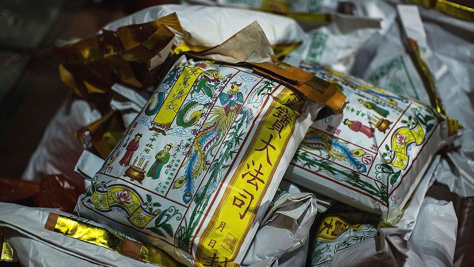 Worshippers make offerings at a park during the month of the Hungry Ghost Festival on August 14, 2015 in Hong Kong