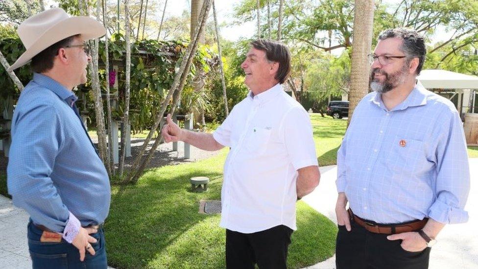 President Jair Bolsonaro greets US Ambassador Todd Chapman during a meeting in Brasilia on 4 July, 2020