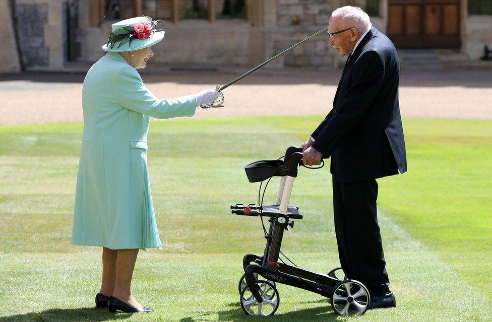 Queen Elizabeth II awards Captain Sir Thomas Moore with the insignia of Knight Bachelor at Windsor Castle on 17 July