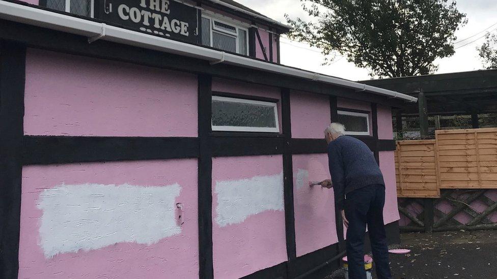 Barrie Martin painting a wall