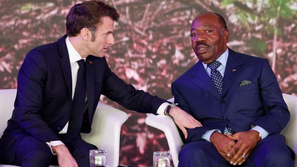 Gabon's President Ali Bongo (R) speaks to French President Emmanuel Macron (L)