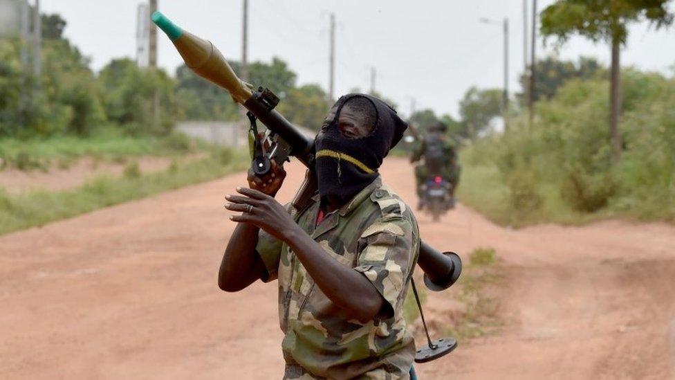 A mutinous soldier holds a RPG rocket launcher inside a military camp in the Ivory Coast's central second city Bouake, on May 15, 2017.