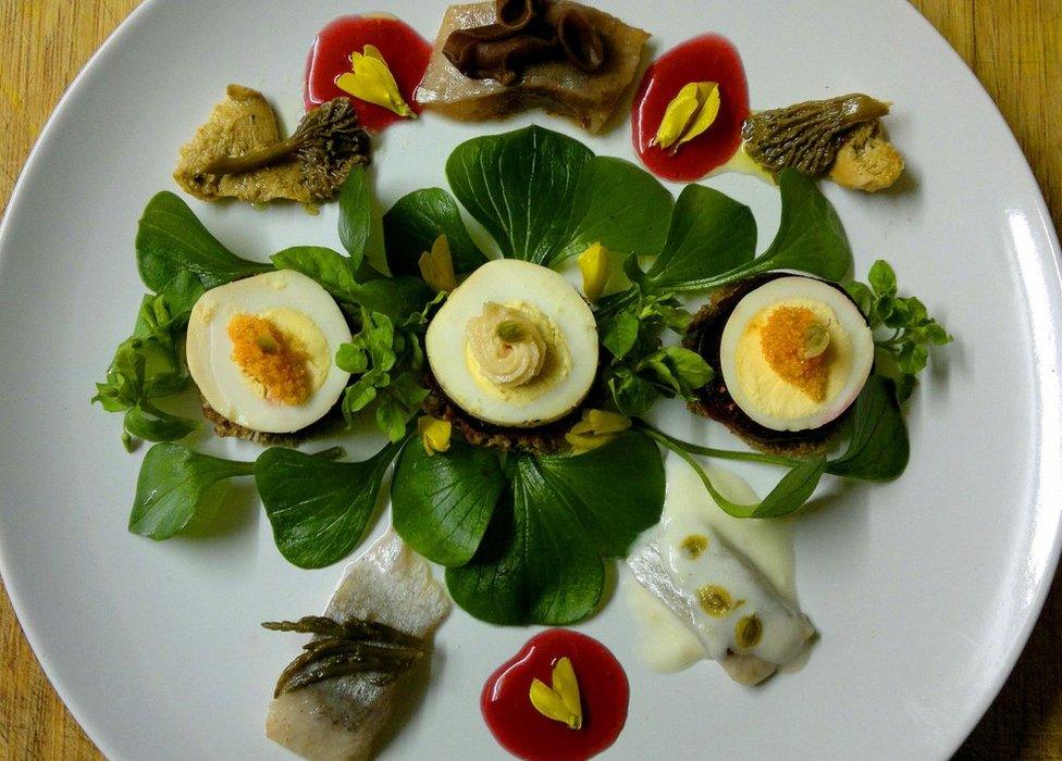 Herring pickled 3 ways with pink purslane, beetroot, pumpernickel, smoked egg, creamed roe, preserved chanterelles, hedgehog fungi & jelly ear, sweet elderberry vinegar and broom flowers.