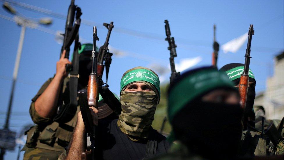 File photo - Hamas militants hold weapons as they celebrate the release of Palestinian prisoner Mohammed al-Bashiti, in Rafah, July 2016.