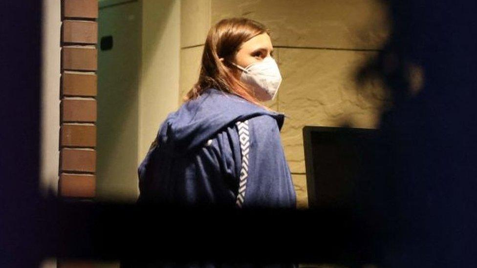 Krystina Timanovskaya walks with her luggage inside the Polish embassy in Tokyo