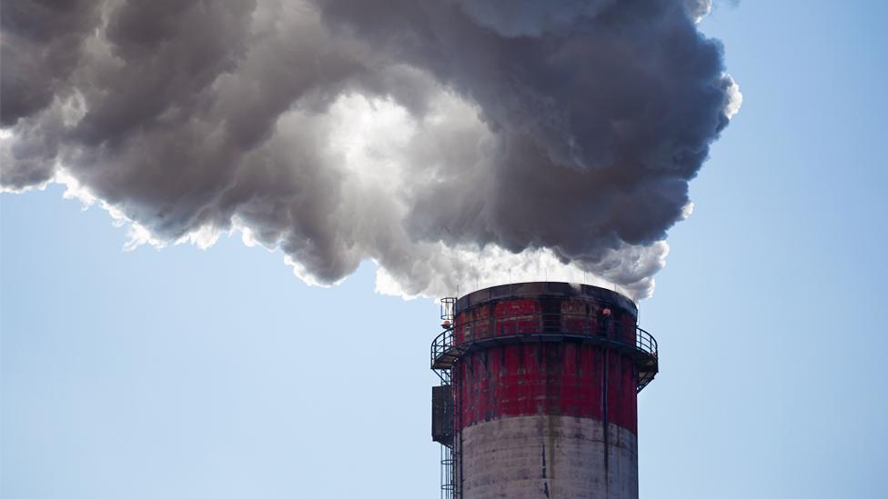 Stock image of smoke rising from the chimney of a coal fired power plant in Poland