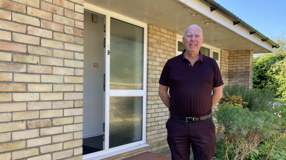 Phil Cotterell outside the front door of the bungalow