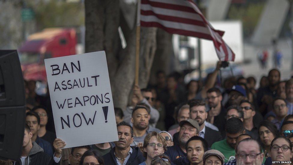 Protesters gathered holding a sign saying: Ban assault weapons now