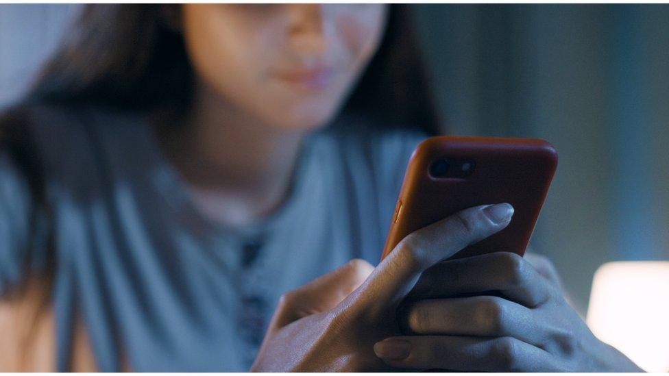 Woman holding mobile phone