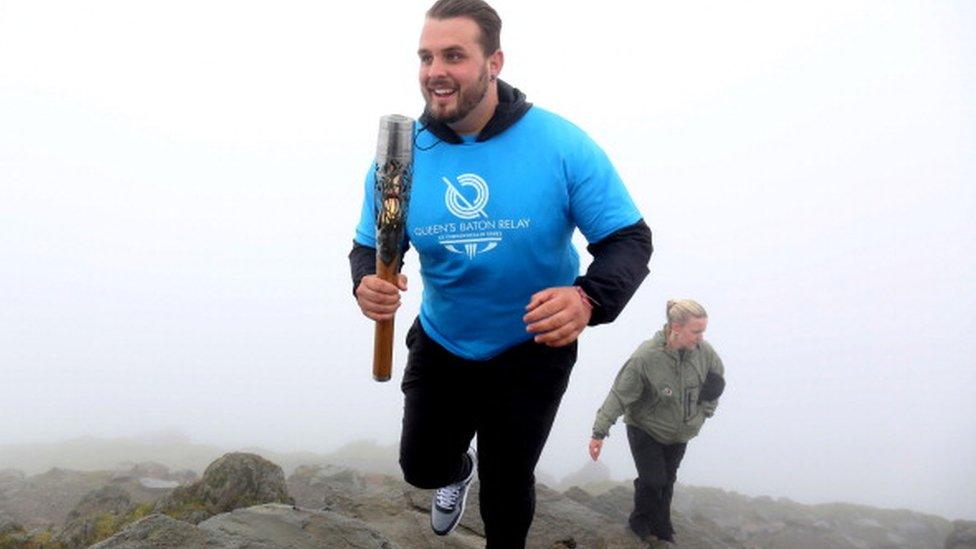 Aled Sion carrying the Queen's Baton up Snowdon