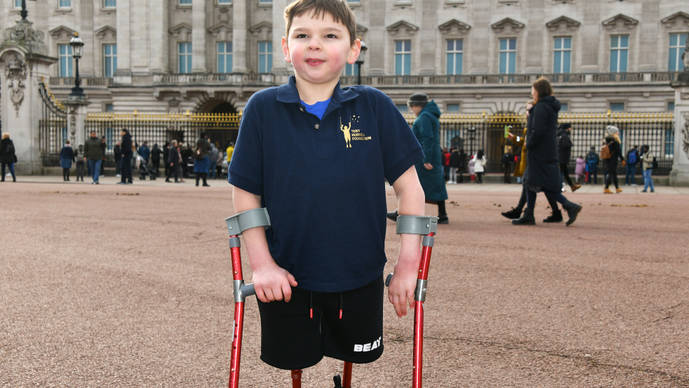 Tony Hudgell poses outside Buckingham Palace to celebrate Jack Hopkins running 100 days to raise funds for the Tony Hudgell Foundation on 5 February 2022 in London