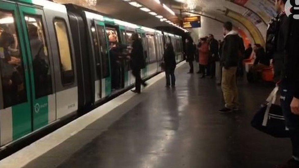 Image of a man being pushed off the Metro in Paris