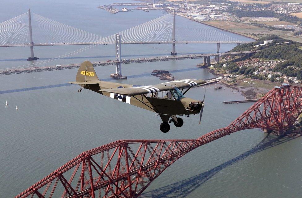 Jim McTaggart takes his 1940 Piper Cub, with its US Army D-Day reconnaissance aircraft markings, for a practice flight over the Forth Rail Bridge,Forth Road Bridge and the new Queensferry Crossing ahead of the aircraft"s appearance at ScotlandÕs National Airshow at East Fortune, East Lothian on Saturday 22 July.