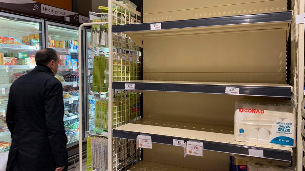 Empty shelves in a Milan shop, 25 Feb 20