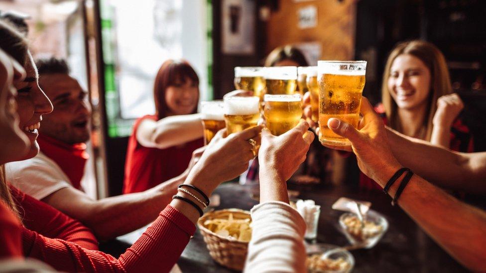 People drinking in a pub