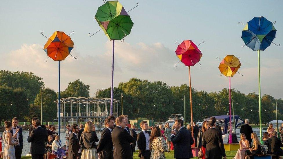 Umbrellas and people at the Henley Festival