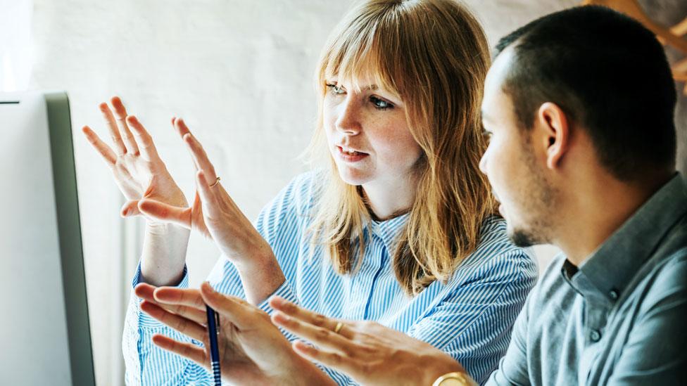 A man and woman working together in an office