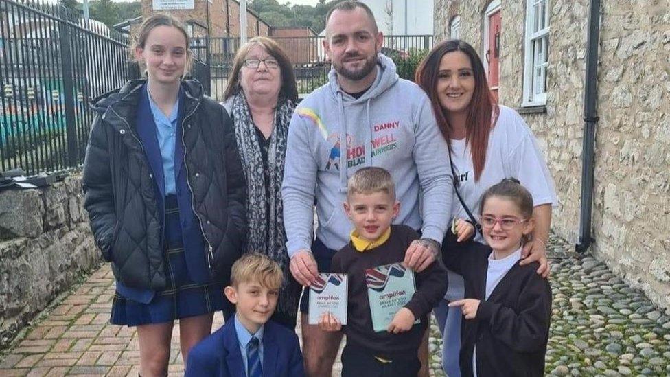 Daniel Thomas and Rachel Kyrki, Albie’s parents with Albie and some of his siblings and family members