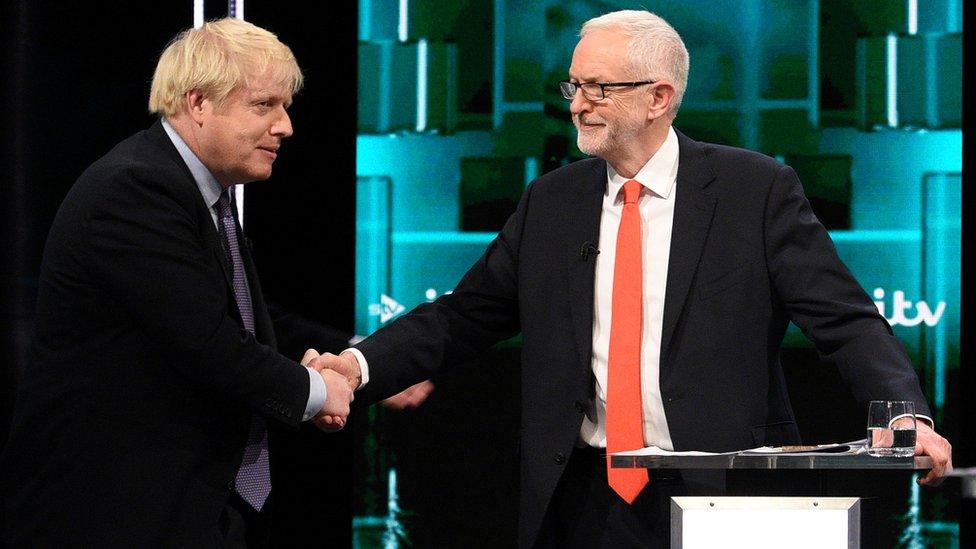 Conservative leader Boris Johnson and Labour leader Jeremy Corbyn shake hands during a televised debate ahead of general election in London, Britain, November 19, 2019