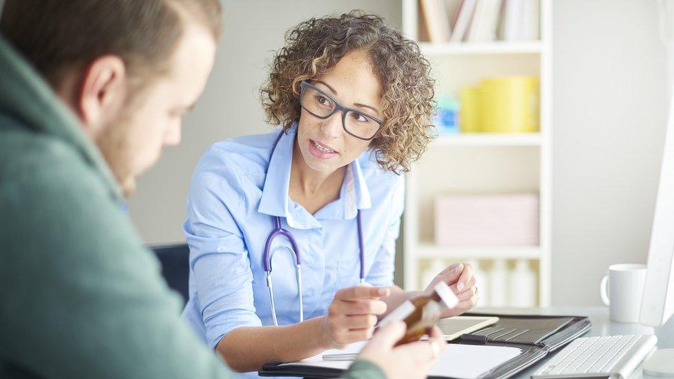 Female GP showing male patient medication